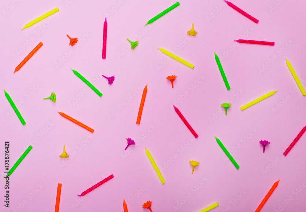 colorful wax holiday candles on a pink background colorful wax holiday candles on a pink background