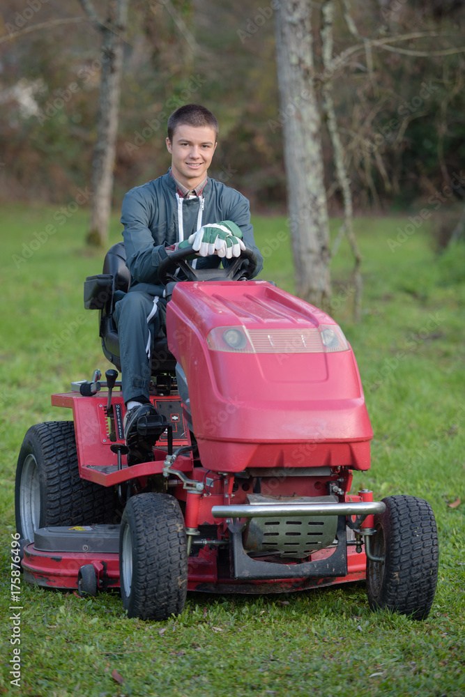 Fototapeta premium Portrait of man driving mower