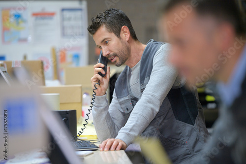 businessman on phone at warehouse
