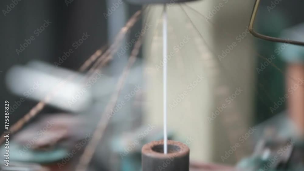 Winding of metal wire on a bobbin in production Winding of metal wire on a bobbin in production