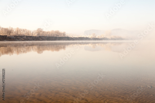 Morning on the river early morning reeds mist fog and water surface on the river