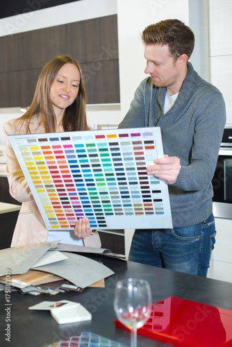 Couple looking at large color chart