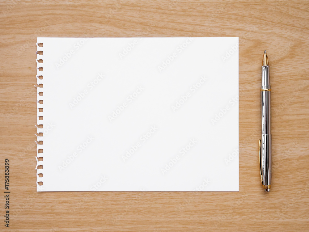 paper and pen on table paper and pen on table