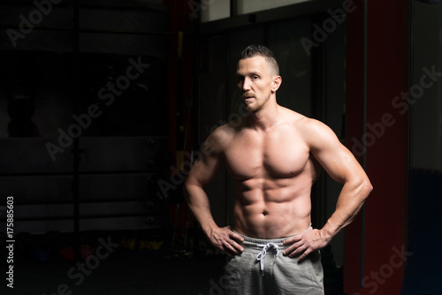 Muscular Man Flexing Muscles In Gym © Jale Ibrak