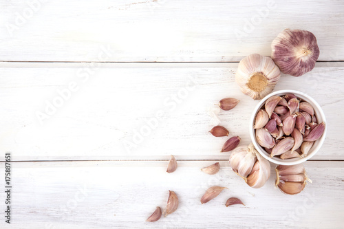 Close up group of garlic on white wooden table board , top view or overhead shot with copy space