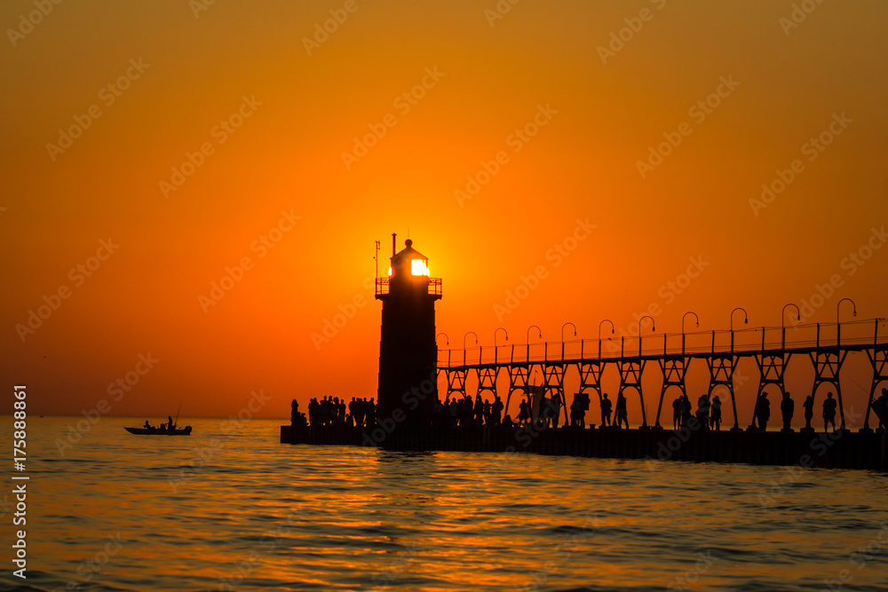 lighthouse and pier at sunset on lake michigan lighthouse and pier at sunset on lake michigan
