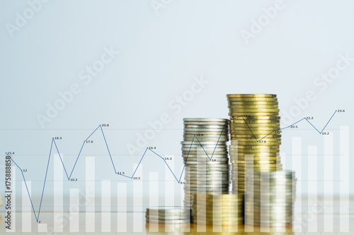 Double exposure Stacks of coins on working table witg financial graph chart, finance and business concept, shallow focus.