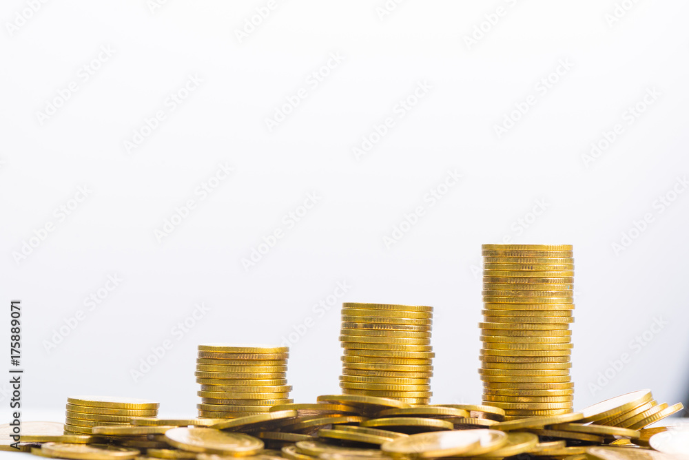 Increasing columns of coins, piles of gold coins arranged as a graph on white background Increasing columns of coins, piles of gold coins arranged as a graph on white background