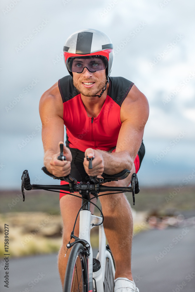 Fototapeta premium Professional cyclist biking on road bike training for triathlon competition on road bicycle in Hawaii. Triathlete working out outdoors. Man sport athlete.