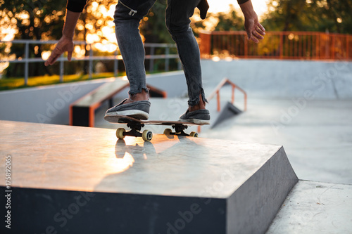 Cropped image of a skater boy practicing