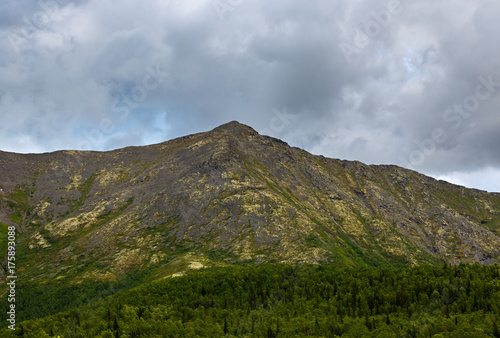Top mountain Khibiny in the form of a background of the cloudy sky.