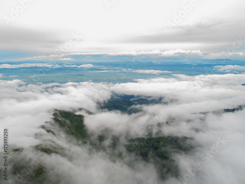 Top of mountain with view into misty valley. Foggy valley mountain view. Beautiful nature.