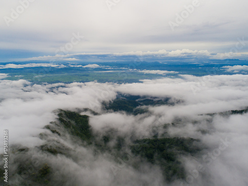 Top of mountain with view into misty valley. Foggy valley mountain view. Beautiful nature.