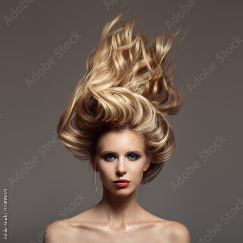 Portrait of blonde woman. Hair storm on her head.