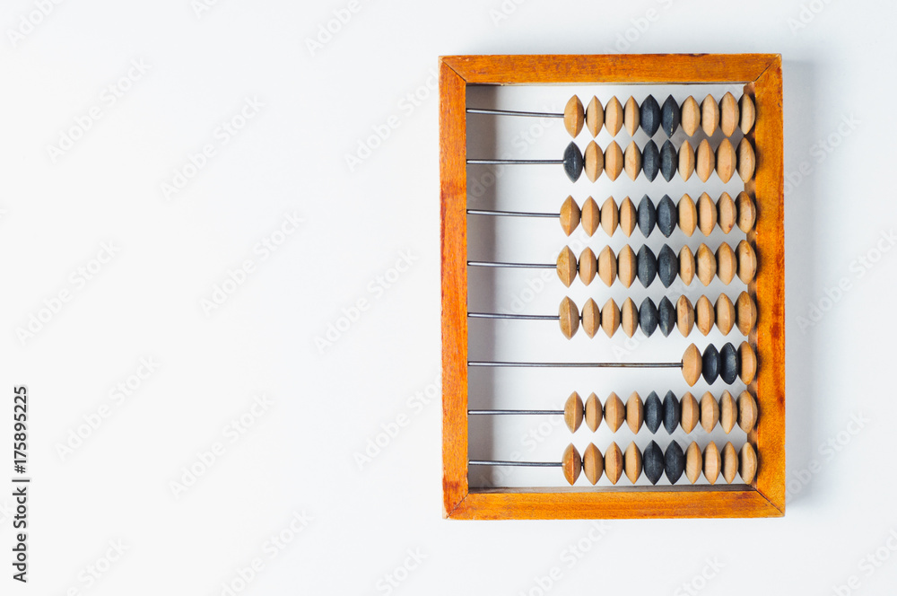 Old wooden abacus on white background. The concept of bookkeeping, business or saving money Old wooden abacus on white background. The concept of bookkeeping, business or saving money