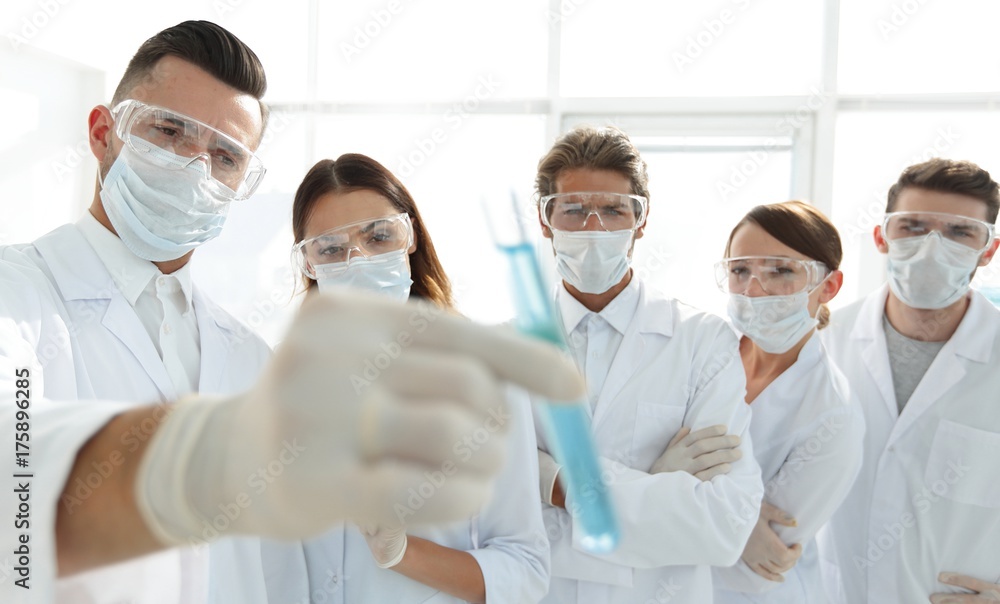 background image is a group of medical workers working with liquids in laboratory background image is a group of medical workers working with liquids in laboratory