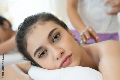 Beautiful young woman getting salt massage.