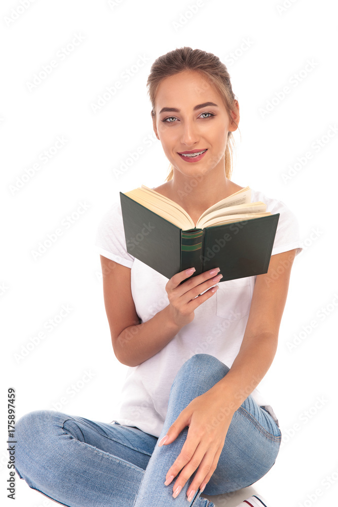 happy young woman reading a novel happy young woman reading a novel