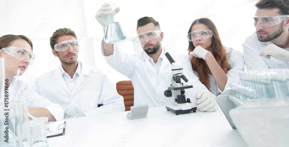 Team of scientists working together at the laboratory Team of scientists working together at the laboratory