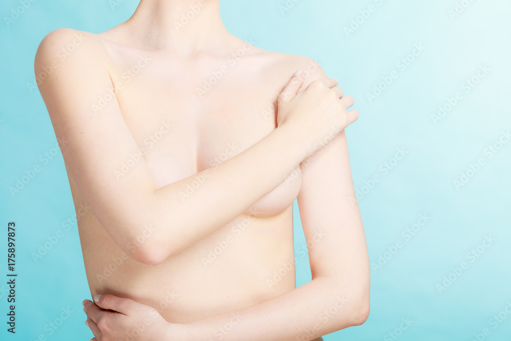 Fototapeta premium Bare woman covering her breast with hands