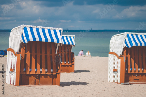 Colourful beach roofed chairs in Travemunde, Germany photo