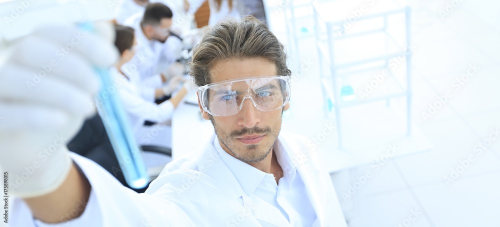tube with reagents on blurred background laboratory. tube with reagents on blurred background laboratory.