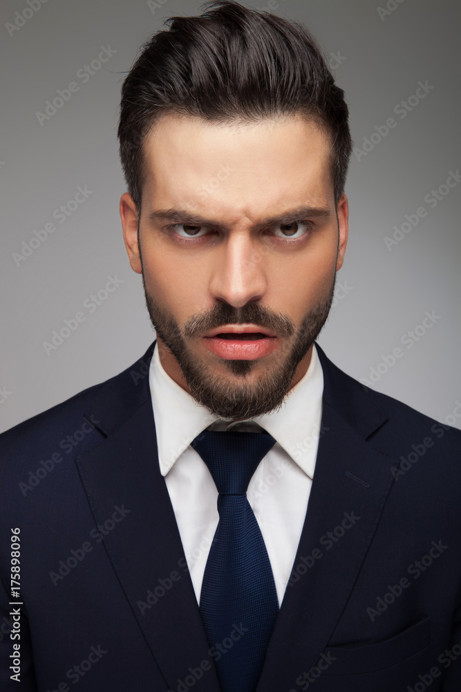 furious young business man looking like a mad man furious young business man looking like a mad man