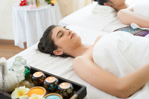 Asian beautiful woman lying relax on white bed in spa