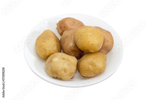 Potatoes boiled in their skins on a white dish