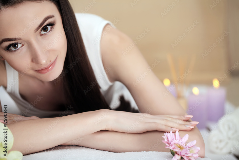 Obraz premium Beautiful young woman lying on massage table in spa salon