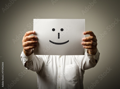 Man is holding white paper with smile. Happy concept.