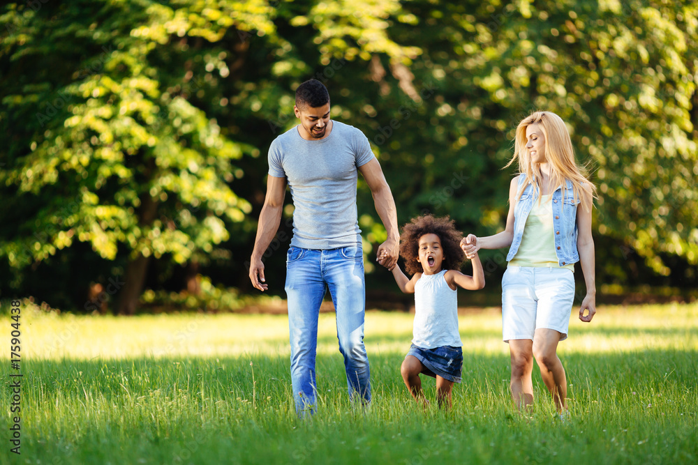 Happy young couple spending time with their daughter