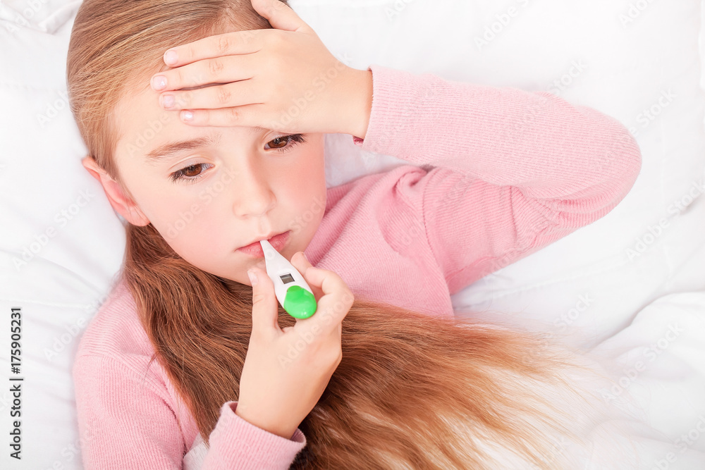Sick girl resting in bed with fever meassuring temperature with Sick girl resting in bed with fever meassuring temperature with