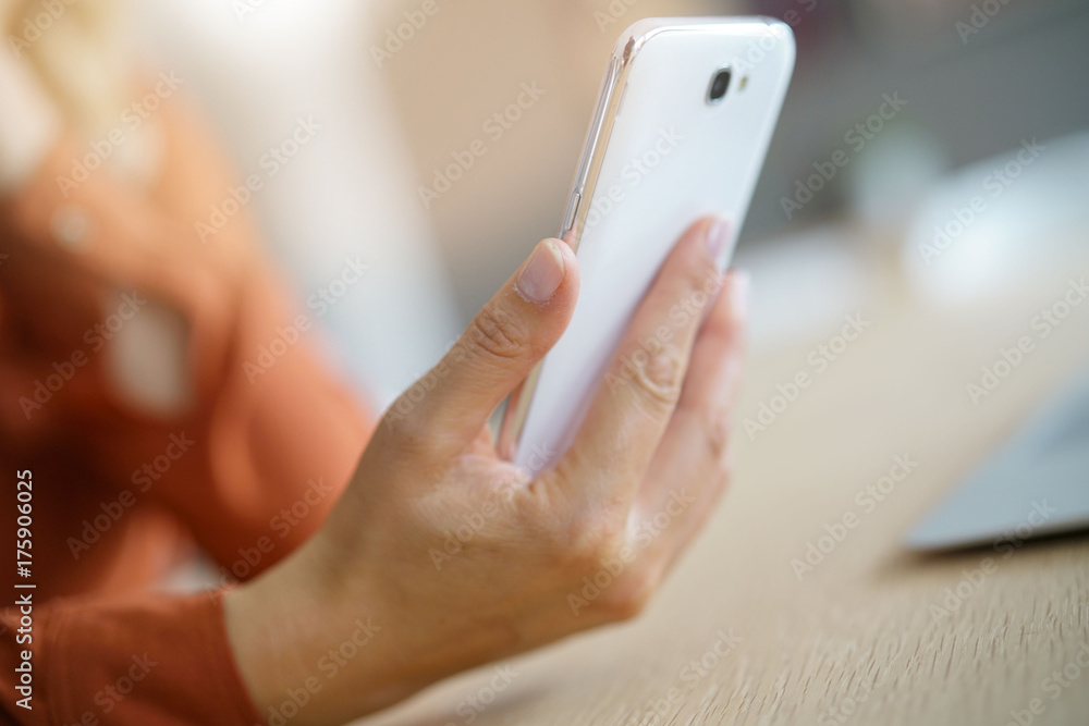 closeup of woman's hand using smartphone
