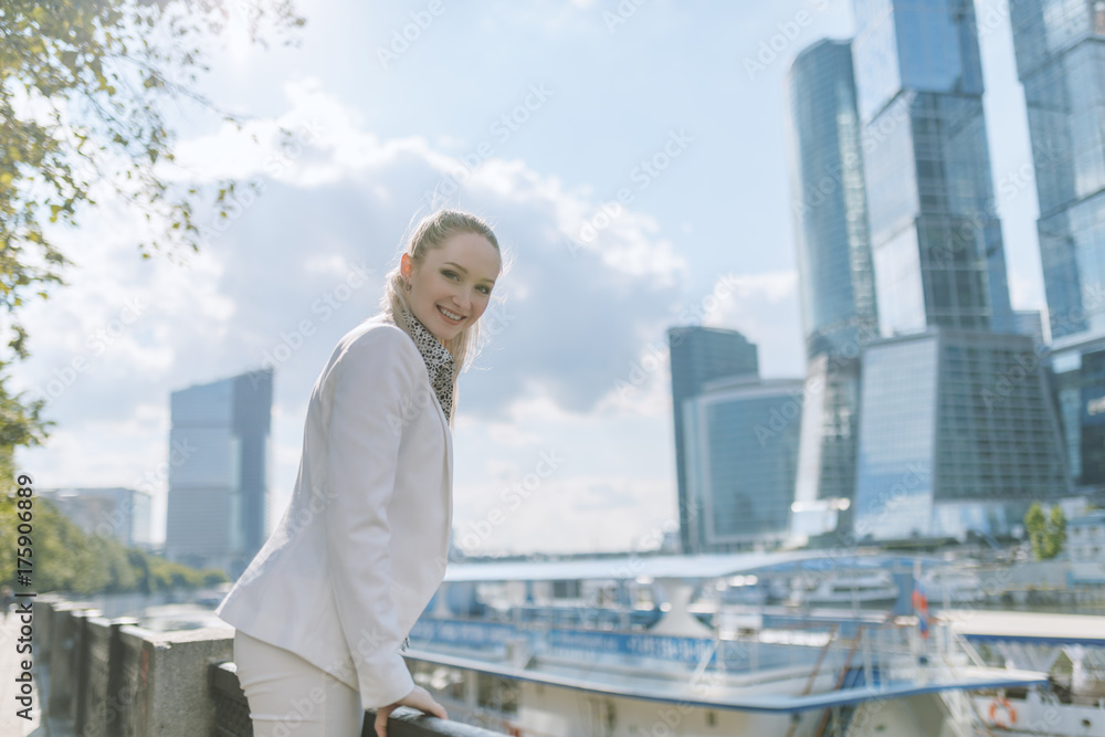 Outdoors portrait of young woman in white jacket. Outdoors portrait of young woman in white jacket.