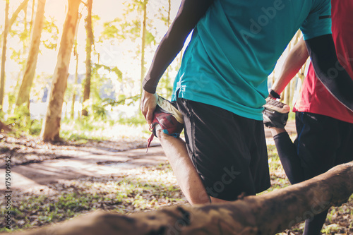 men trail runner athletes worming up for outdoor practice.