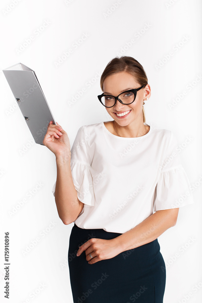 Seductive woman in office suit poses with grey folder