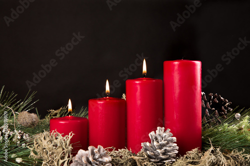 red advent candles with green pir and pinecone photo