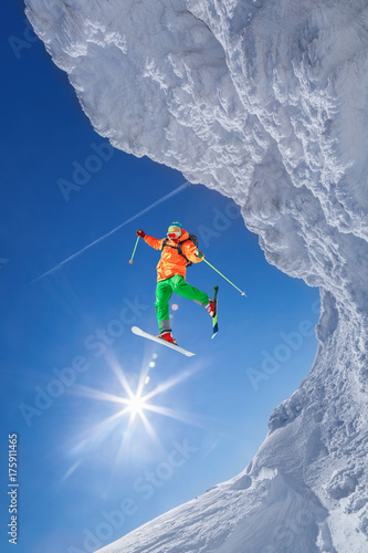 Skier jumping against blue sky from the rock © Tomas Marek