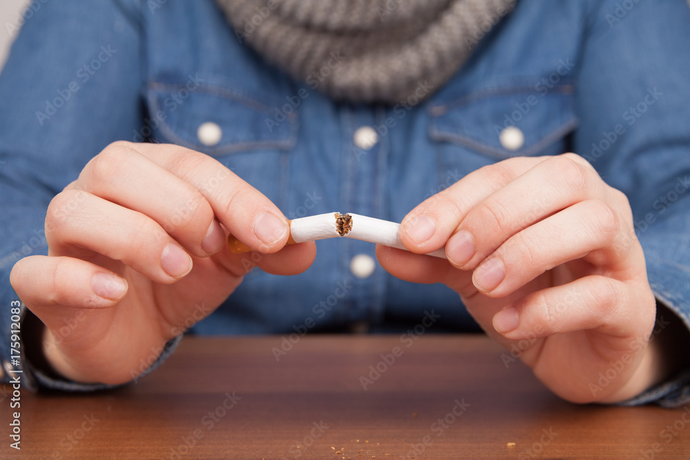 Fototapeta premium woman breaks a cigarette