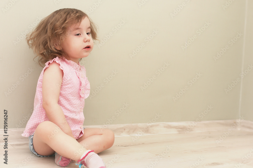 Young kid playing on a floor in a room Young kid playing on a floor in a room