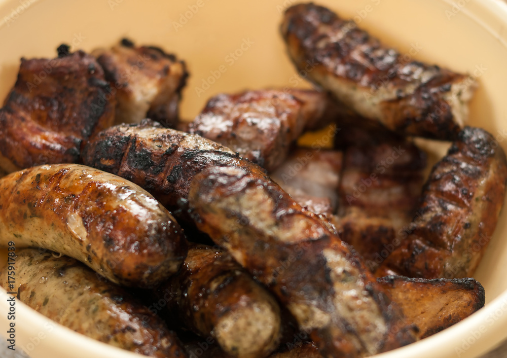 Appetizing fried sausages on a barbecue.