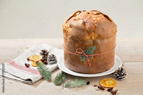 Italian Christmas cake panettone on woodden table with ribbon