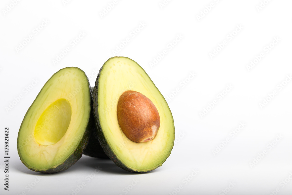 avocado cut in half on a white background