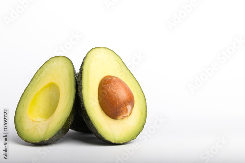 avocado cut in half on a white background