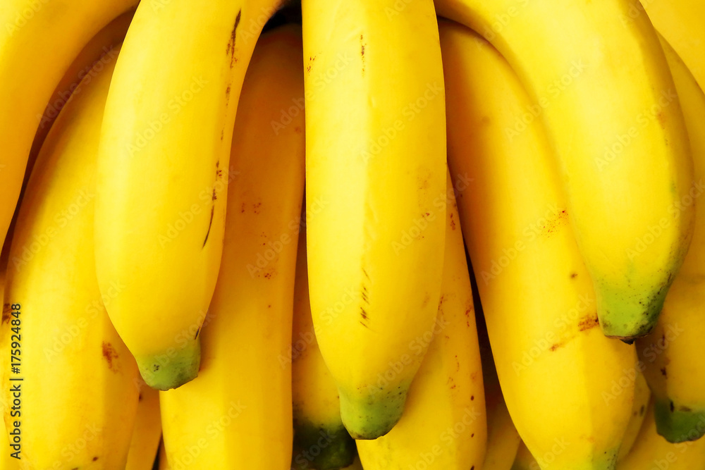 Closeup of fresh bananas yellow in nature light.