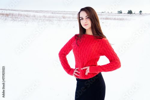 Girl in the winter on a snowy field.