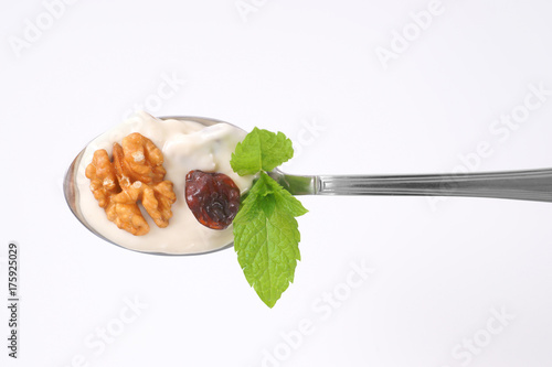 spoon of cream cheese with nuts and raisins