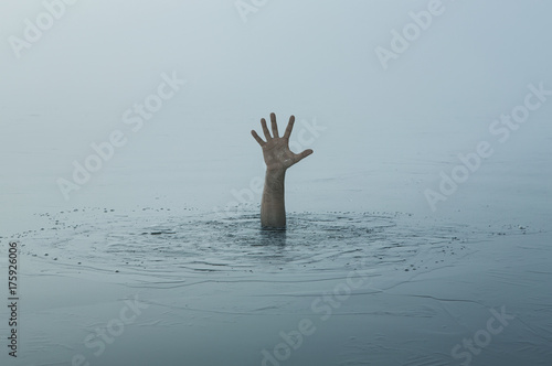 Danger, problems concept. Close up of human hand drowning in the lake