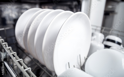 Clean dishes in dishwasher machine after washing